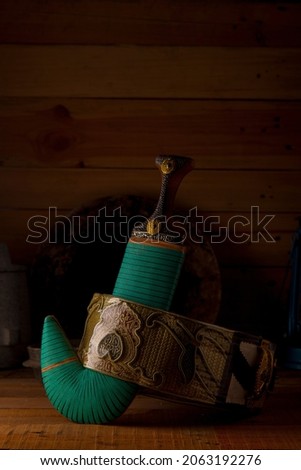 Yemeni dagger on wooden table Royalty-Free Stock Photo #2063192276
