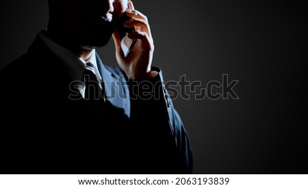 Male image of a scammer making a phone call Royalty-Free Stock Photo #2063193839