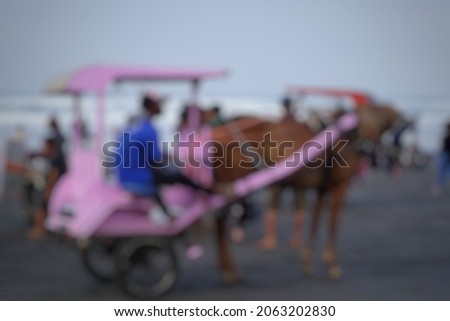 Defocused horse-drawn carriage on the beach. Good for quotes background and other projects.