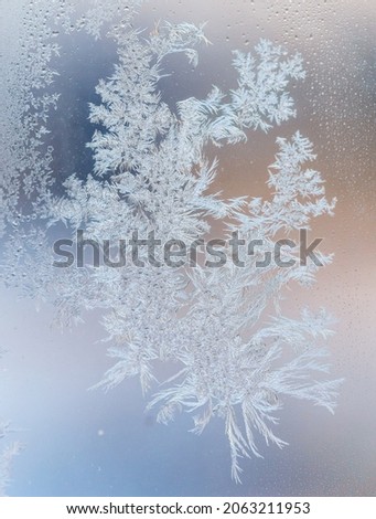 Snowflakes on glass as a background. Close-up