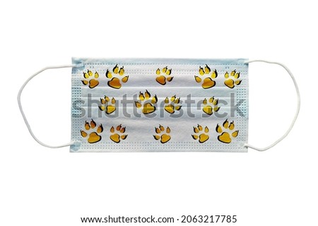 Blue medical mask with a tiger pattern on a white background close-up.