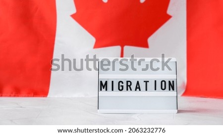 The National Flag of Canada. Lightbox with text MIGRATION Canadian Flag or the Maple Leaf. Patriotism. International relations concept. Independence day. Immigration