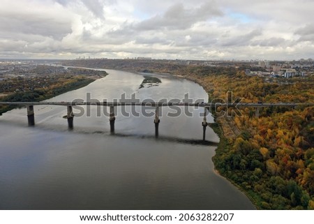 Transport bridge across the river. Nizhny Novgorod, Myzinsky bridge. Aerial photography of the river, and the bridge over the river from a drone. Shallows on the river, ecology and architecture.