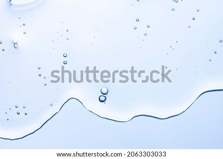 Cream gel gray blue transparent cosmetic sample texture with bubbles isolated on white background Royalty-Free Stock Photo #2063303033