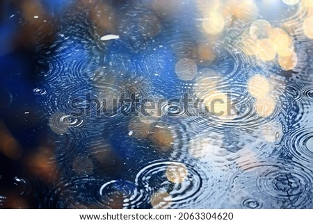 rain puddle circles, aqua abstract background, texture autumn water Royalty-Free Stock Photo #2063304620