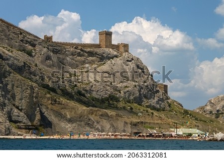 View from the sea on the wall and towers of the Genoese fortress on the rock. Fortress in Sudak Royalty-Free Stock Photo #2063312081