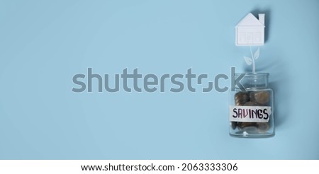 Coins in glass savings jar, top view. Euro currency money on blue background for business and finance concept