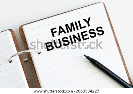 FAMILY BUSINESS concept write text on notebook