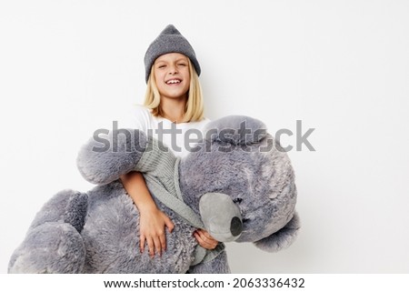 happy cute girl fun teddy bear joy on a light background