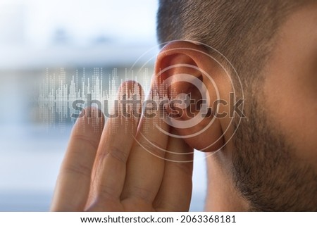 Young man with hearing problems or hearing loss. Hearing test concept. Royalty-Free Stock Photo #2063368181