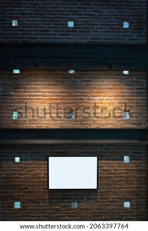 Beautiful black wooden photo frames with light and shadow on the brick wall background decoration. Concept retro interior vintage design with space for text and advertising.