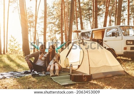 Untouched nature. Young couple is traveling in the forest at daytime together.