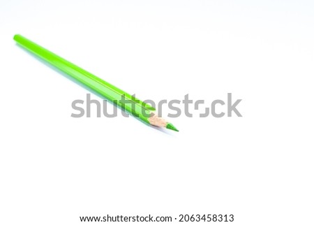 Close-up photo of colored pencils green on a white background concept art design copy space school and office.