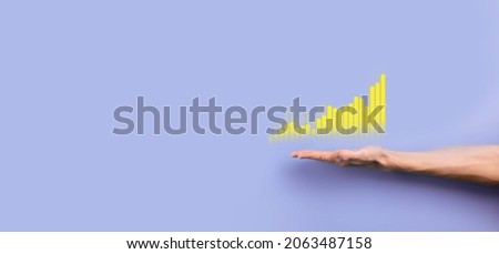 Male hand holding graph icon.checking analyzing sales data growth graph chart and stock market on global networking. Business strategy, planning and digital marketing.