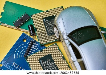 CPU chip and semiconductors with car toy. Global car chip shortage. Micro-chip shortage creates dearth of new cars. Computer chip shortage stalls car industry production Royalty-Free Stock Photo #2063487686
