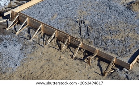 Timber formwork with metal reinforcement for pouring concrete and creating a solid foundation for a building or sauna. Construction process.