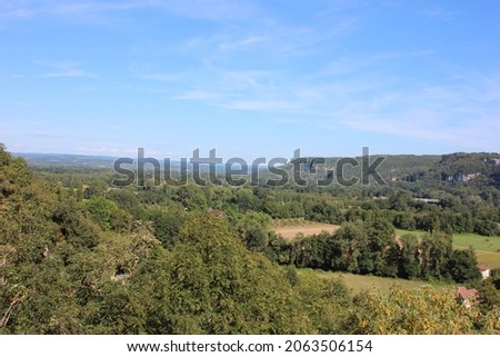 Beautiful wide view over the French mountainous landscape of the Dordogne. Photo was taken on a hot day in summer.