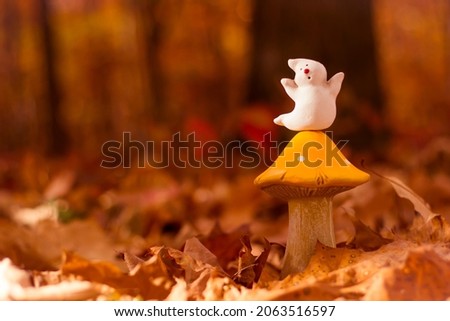 Halloween ghost and mushroom toy in forest