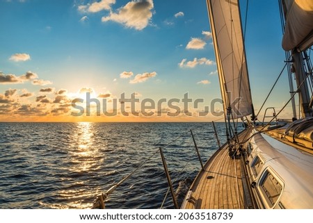 Cruising sailboat sailing in the Mediterranean Sea at sunset Royalty-Free Stock Photo #2063518739