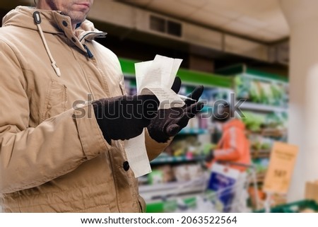Man thinking how to pay for store bill because of price rising