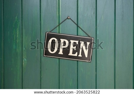 open sign on the glass of the doors in store. welcome sign at the store