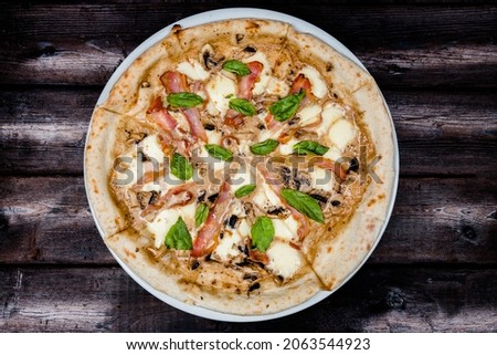 pizza on a plate on a dark background top view