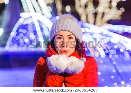 Young pretty funny girl having fun outdoor in winter. Christmas, city and winter holidays concept.
