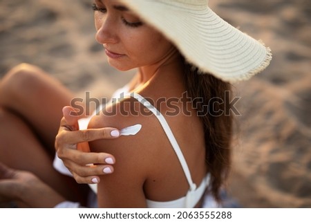 Woman using sunscreen cream. Beautiful girl with sun protection cream	 Royalty-Free Stock Photo #2063555288