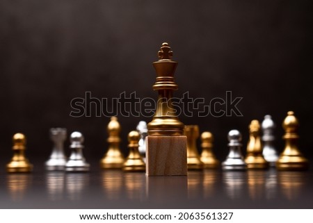Golden king chess standing on a wooden stand. The concept of Leaders in good organizations must have a vision and can predict business trends and assess competitors Royalty-Free Stock Photo #2063561327
