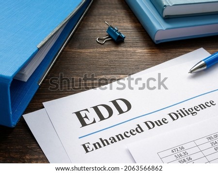 EDD enhanced due diligence papers and blue folder.