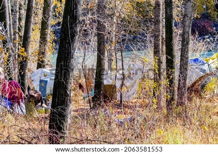 Homeless encampment along Bow River in downtown Calgary, AB Royalty-Free Stock Photo #2063581553