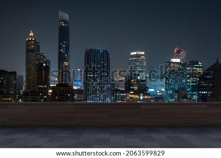 Panoramic Bangkok skyline view, concrete observatory deck on rooftop, night time. Asian corporate and residential lifestyle. Financial city downtown, real estate. Product display mockup empty roof Royalty-Free Stock Photo #2063599829