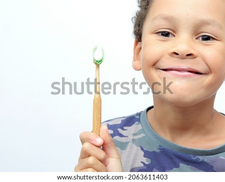 boy brushing teeth with a tooth brush on white background with people stock photo 