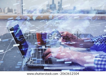 Double exposure of man hands holding a credit card and data theme drawing. E-commerce and technology concept.