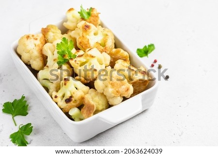 Vegan beer battered cauliflower in baking dish. Space for text. Royalty-Free Stock Photo #2063624039