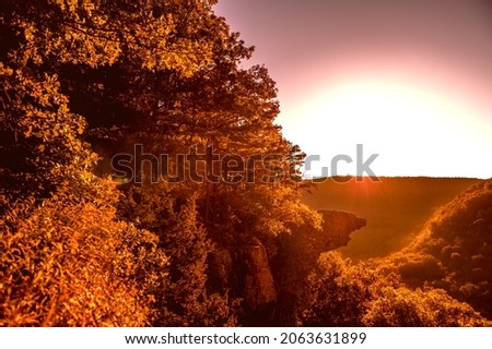 Sunrise at Whitaker Point, known as Hawksbill Crag, during the fall color change of the leaves. Hawksbill is a popular tourist site in the state of Arkansas. Royalty-Free Stock Photo #2063631899