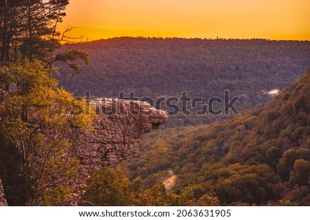 Sunrise at Whitaker Point, known as Hawksbill Crag, during the fall color change of the leaves. Hawksbill is a popular tourist site in the state of Arkansas. Royalty-Free Stock Photo #2063631905