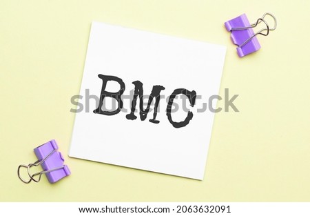 white paper with text bmc on a yellow background with stationery
