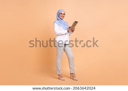 Full body photo of millennial east modern lady write tablet wear headscarf shirt eyewear pants stilettos isolated on beige background