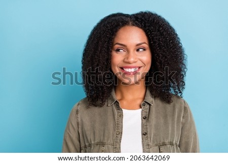 Photo of pretty positive lady toothy smile look interested empty space isolated on blue color background