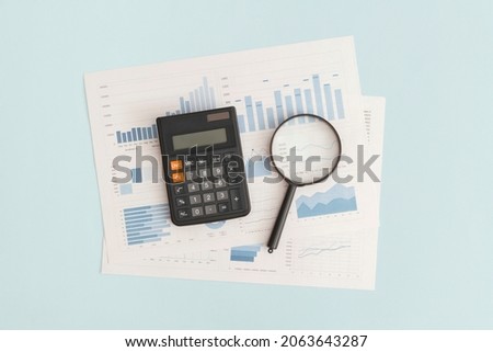 Business graphs, charts, magnifying glass and calculator on table. Financial development, Banking Account, Statistics Royalty-Free Stock Photo #2063643287