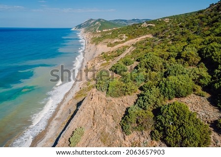 Ocean coastline with waves and highest cliff on coastline. Summer day on sea. Aerial view Royalty-Free Stock Photo #2063657903