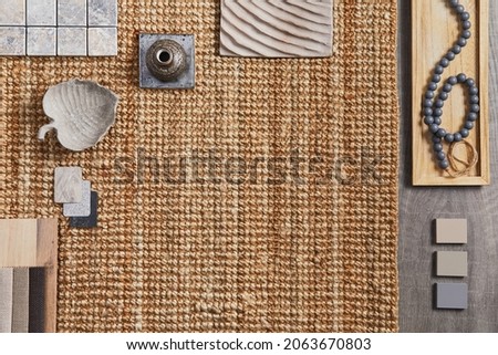 Flat lay of creative architect moodboard composition with samples of building, orange textile and natural materials and personal accessories. Top view, template.