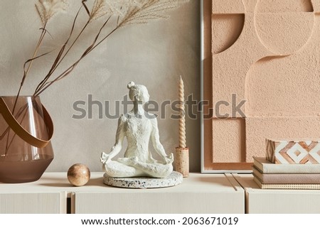 Creative composition of modern beige living room interior design with designed sculpture, structure painting, beige wooden sideboard and boho inspired personal accessories. Template.