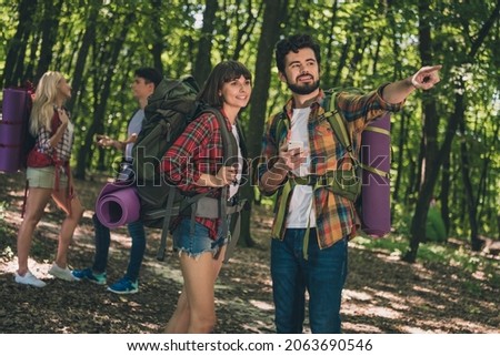 Photo of four best friends happy positive smile hiking route forest talk point finger adventure wanderlust outdoors