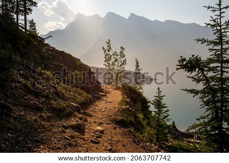 Hiking trail along the edge of a lake. Taken at Lake Minnewanka, Alberta, Canada. Royalty-Free Stock Photo #2063707742