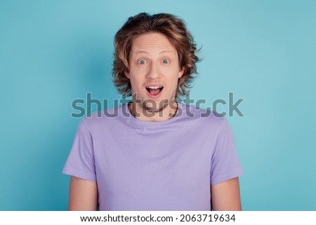 Photo of young handsome man amazed shocked surprised news sale excited isolated over teal color background