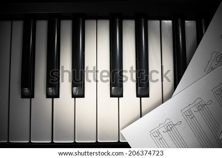 background of piano keyboard and notes with vignette
