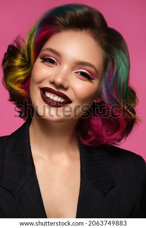 Portrait of beautiful woman with multi-colored hair and evening make-up and hairstyle. Beauty face.
