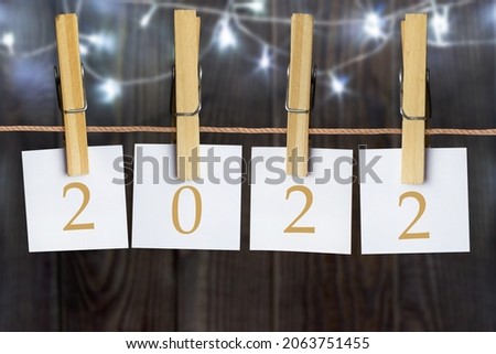 2022 notes hanging by preachers. Blurred background with lights.